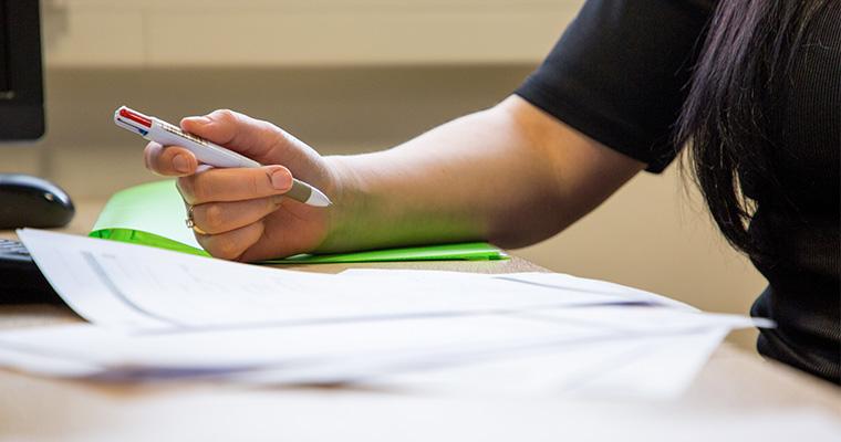 Young person holding a pen