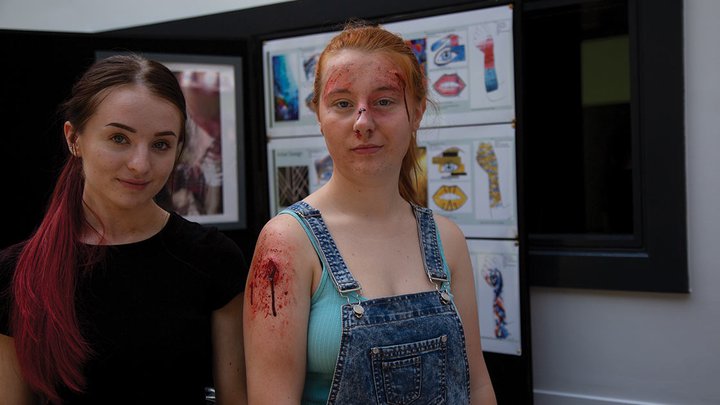 Two students with theatrical make-up applied