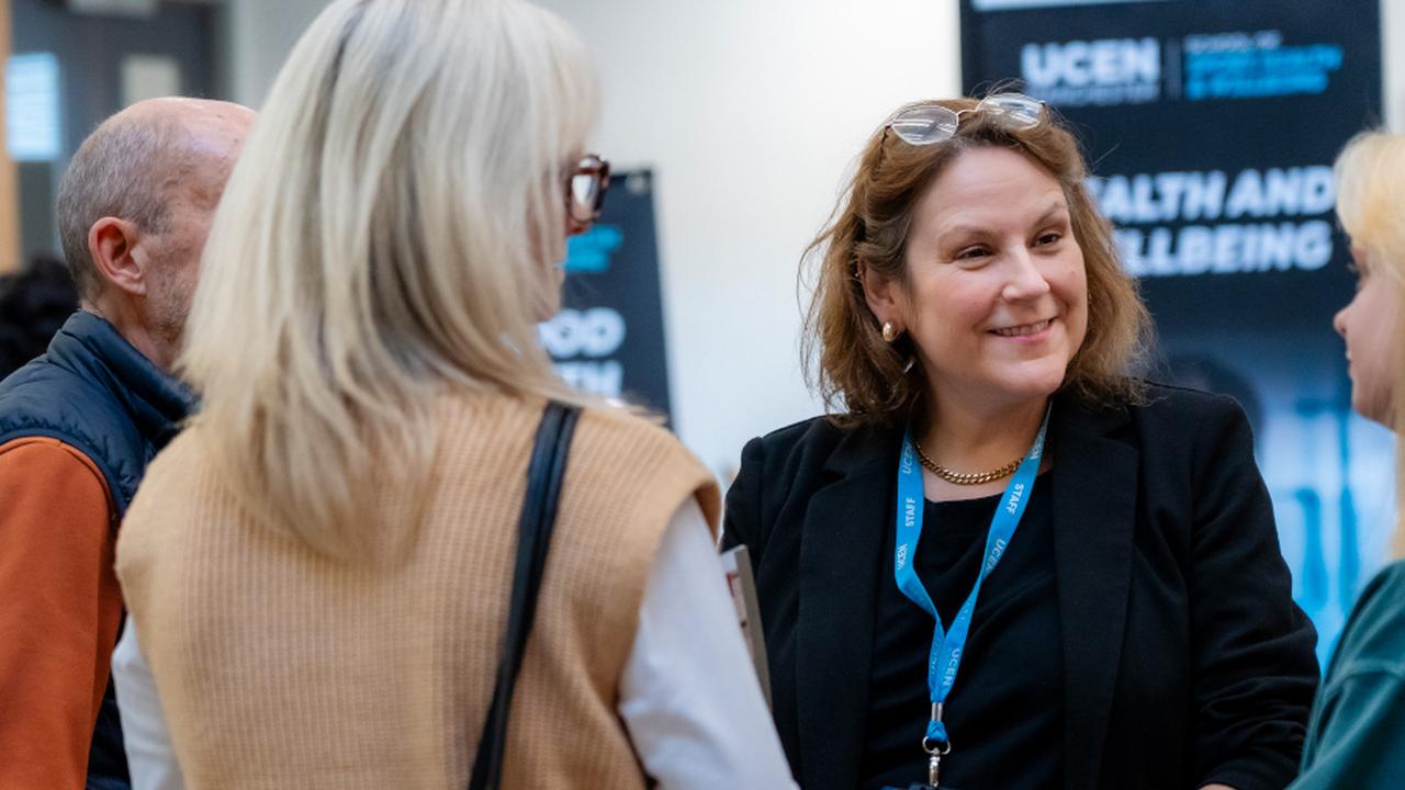 UCEN Manchester's Head of Student Advice, Support and Wellbeing speaking to prospective applicants at an open day.