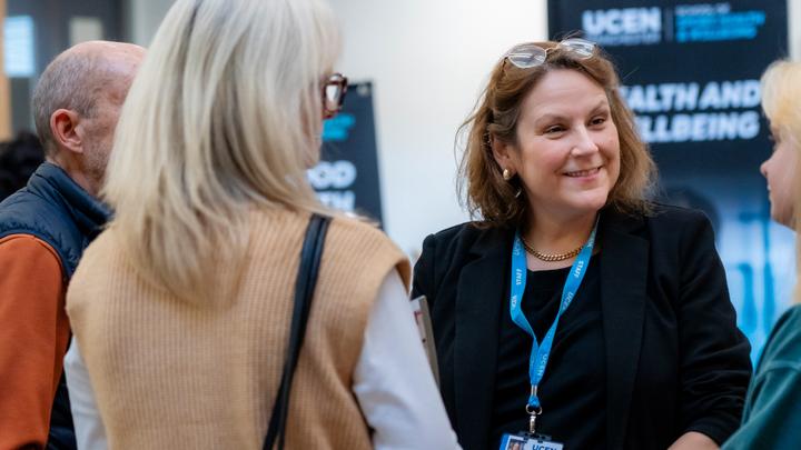 UCEN Manchester's Head of Student Advice, Support and Wellbeing speaking to prospective applicants at an open day.