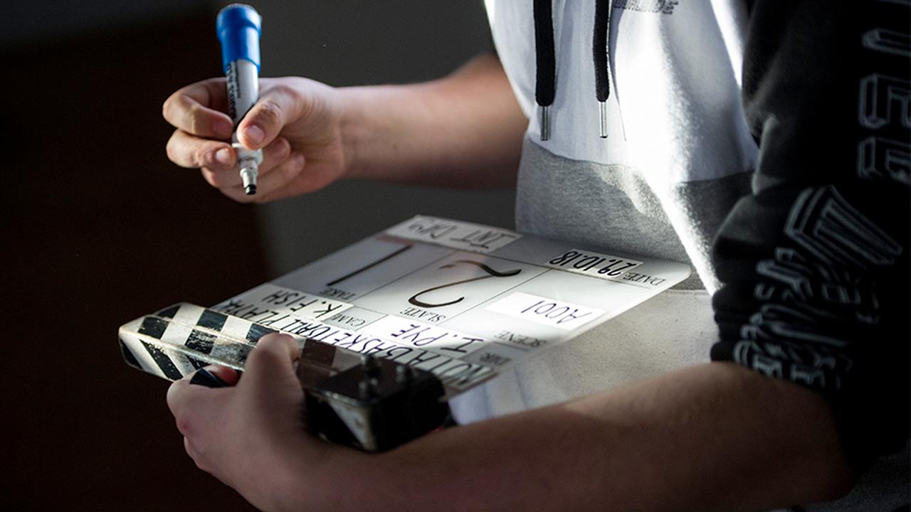 Man writing on a director's board