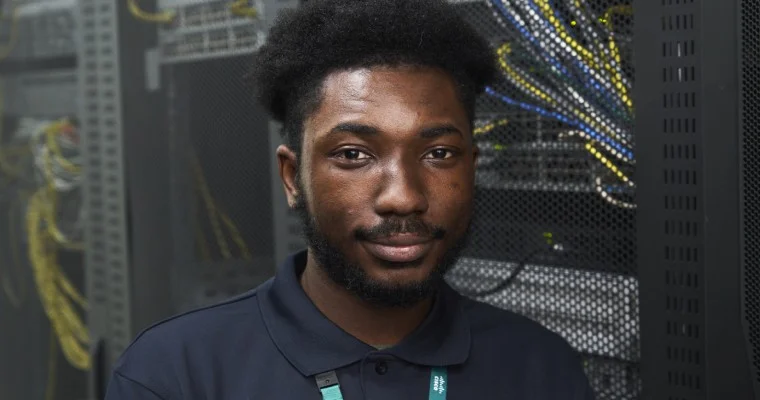 HTQ computing student stood in front of a server