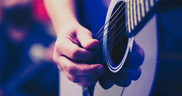 Close-up of someone playing an acoustic guitar