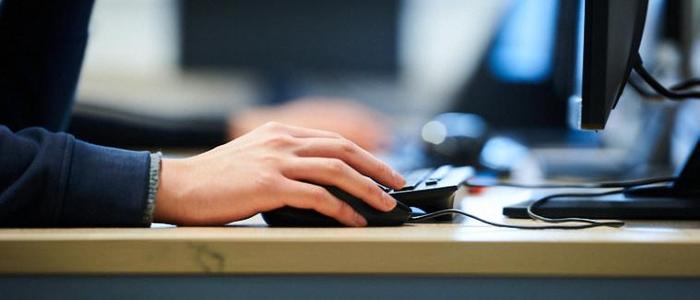 Close-up of someone using a computer mouse