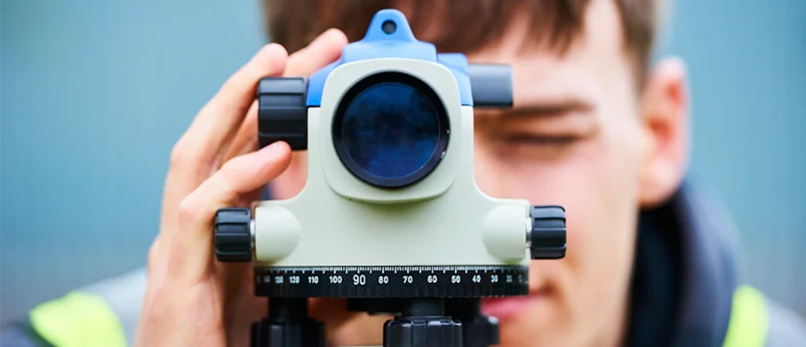 A student using survey equipment