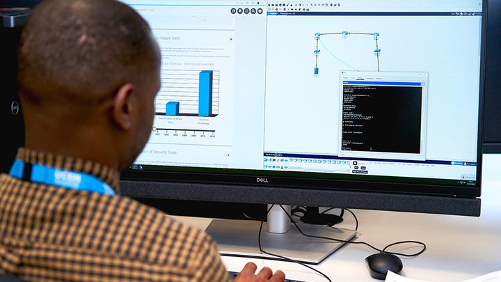 Photograph of a Computing student at UCEN Manchester working on a desktop computer.