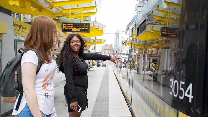 Two people waiting for a tram