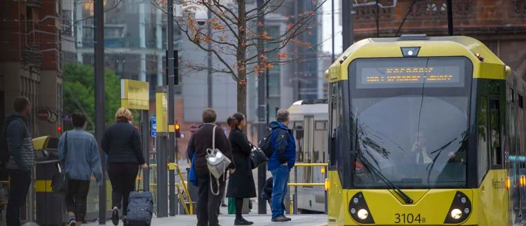 A tram moving around the streets of Manchester