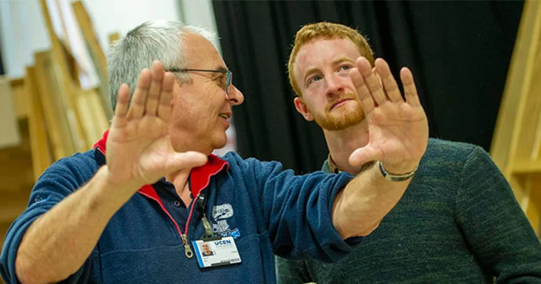Two people smiling and talking to each other