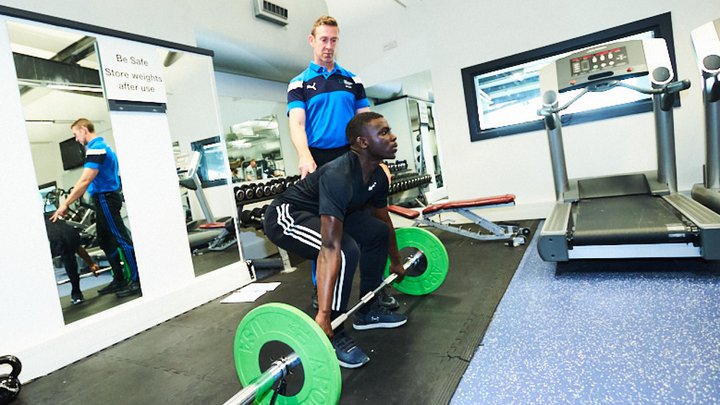 Close-up of a personal trainer instructing someone