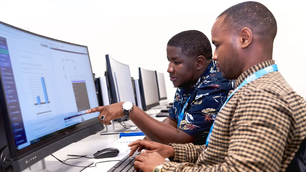 Two people using a computer