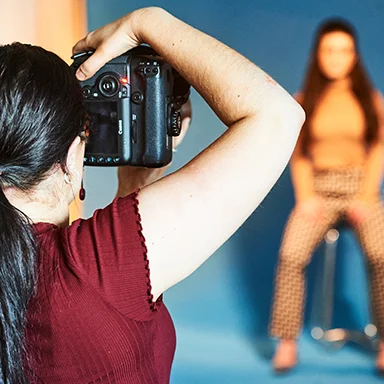 A photographer taking a picture of a model