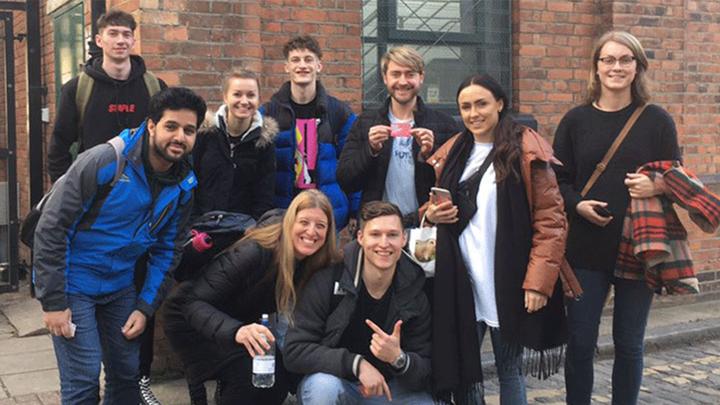Nine creative and photographic design UCEN Manchester students all smiles during their trip to London