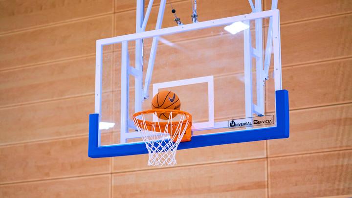 Basketball entering a basketball hoop in the UCEN Sports Hall