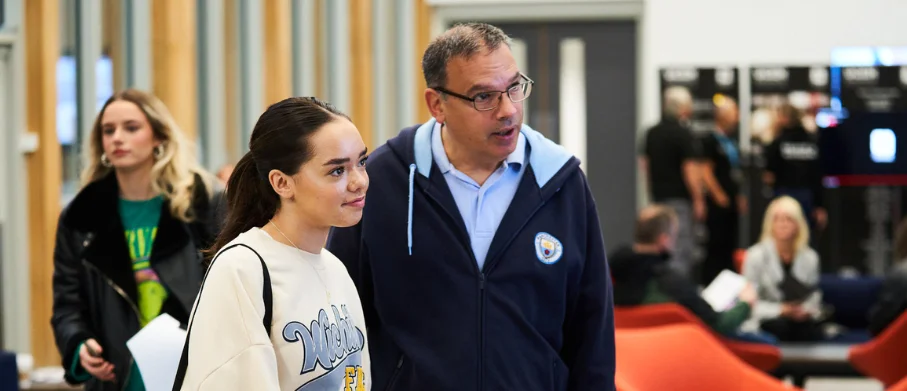 A UCEN Manchester tutor giving advice to a parent