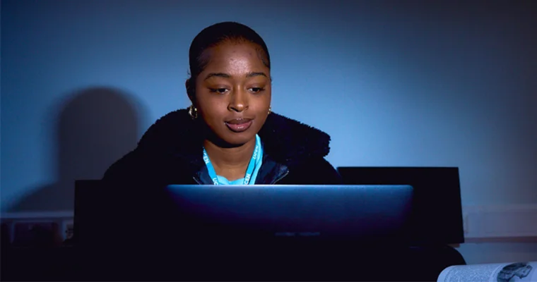 A student sat looking at a computer screen