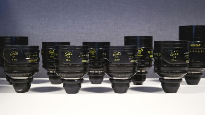 Several camera lenses placed on a surface