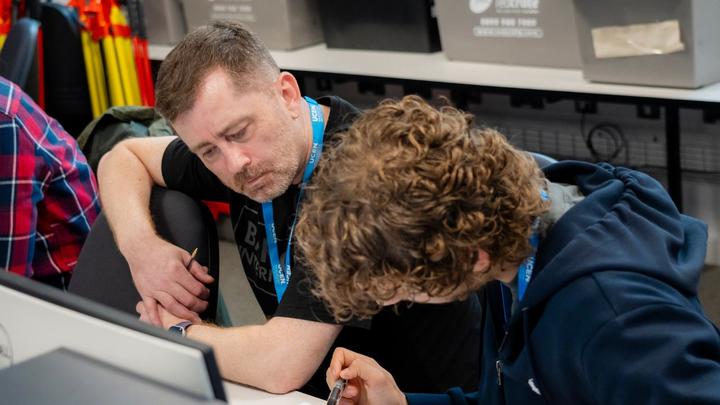 UCEN Manchester student working on an engineering task with support from a tutor.