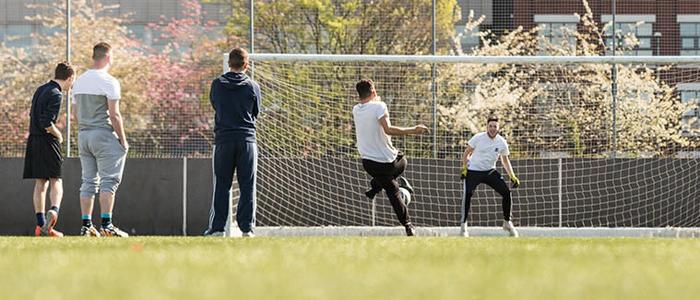 A football team running through drills on the pitch