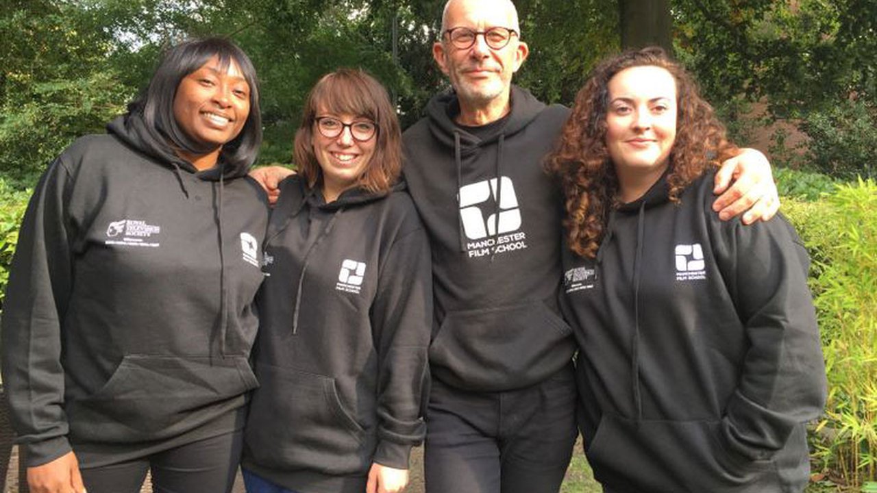 A group of students wearing black hoodies which say manchester film school