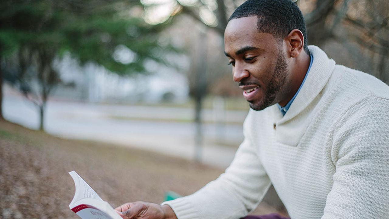 Adult learner reading a book