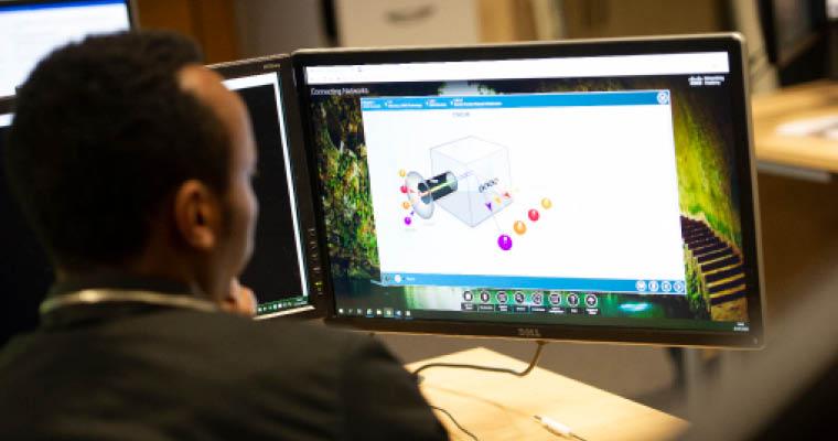 A person looking at computer screens