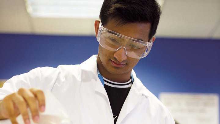 A close-up of a learner working in a lab