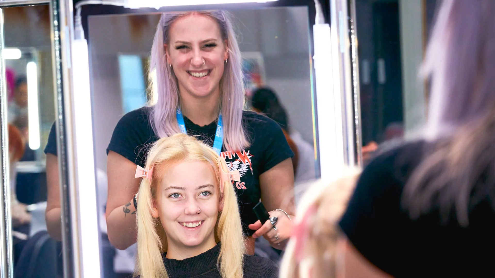 Student doing another students' hair