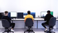 A row of learners sat at computers