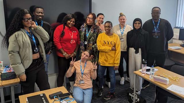 Sharine McKenley-Walters (third from the left) poses for a picture in a classroom with some current UCEN Manchester Criminology and Criminal Justice students.