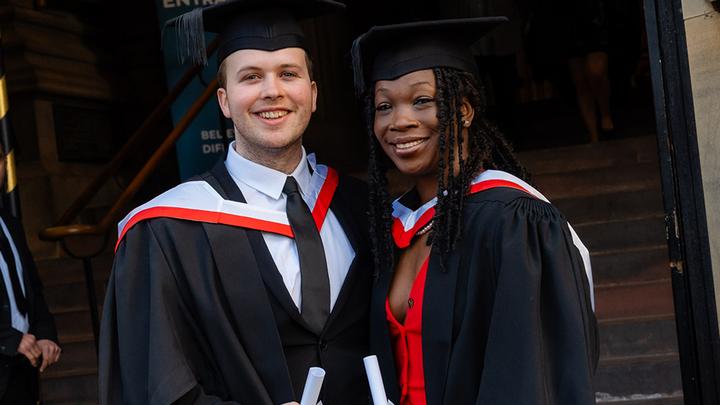 Two UCEN Manchester graduates outside Manchester Cathedral.