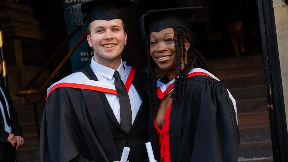 Two UCEN Manchester graduates outside Manchester Cathedral.