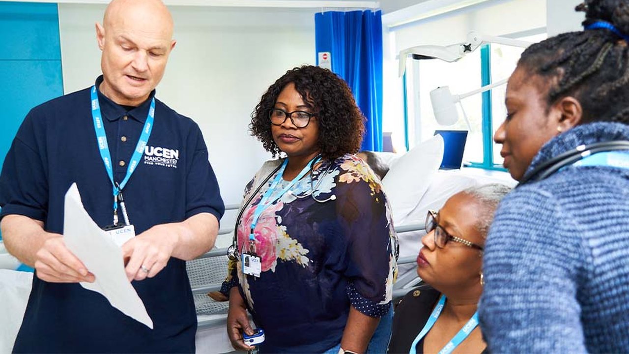 Health tutor Adam Sleeman is teaching three students in the UCEN Manchester hospital ward.