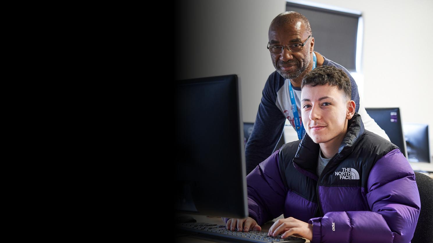 Two people using a computer