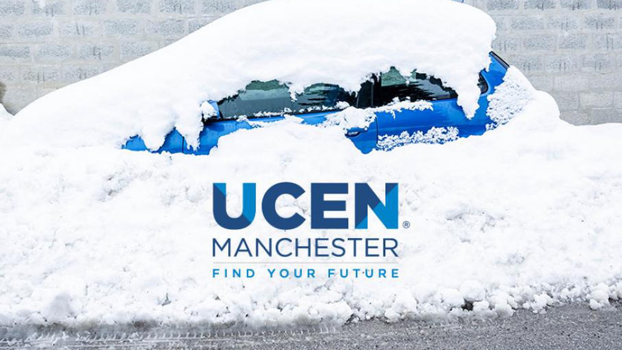 A blue car covered in snow with the text of ucen Manchester