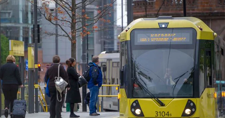 A tram moving around the streets of Manchester