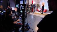 A team of camera operators filming on set