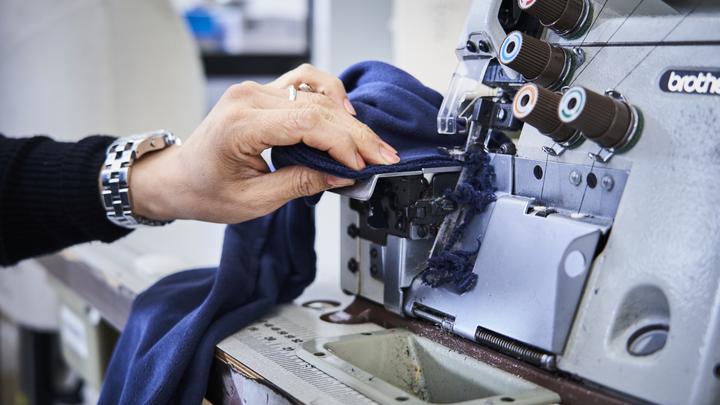 Fashion student close up working on sewing equipment