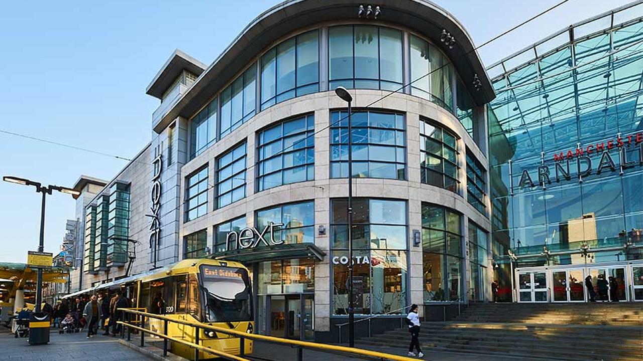 A Metrolink tram outside the Arndale Shopping Centre in Exchange Square, Manchester