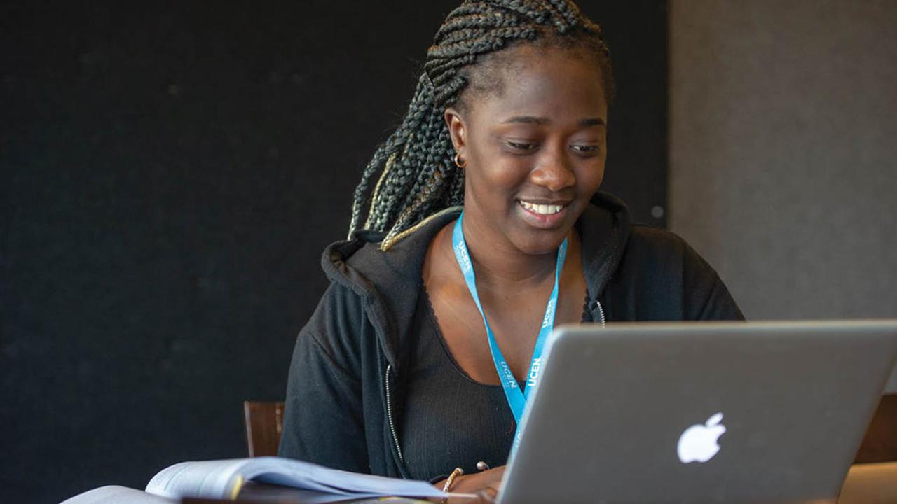 UCEN Manchester student and laptop.