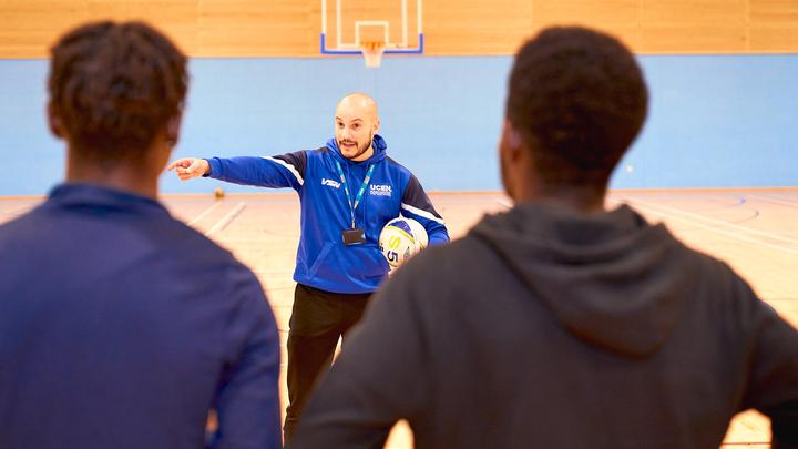 UCEN Students being directed in the Sports Hall by a UCEN Sport Tutor