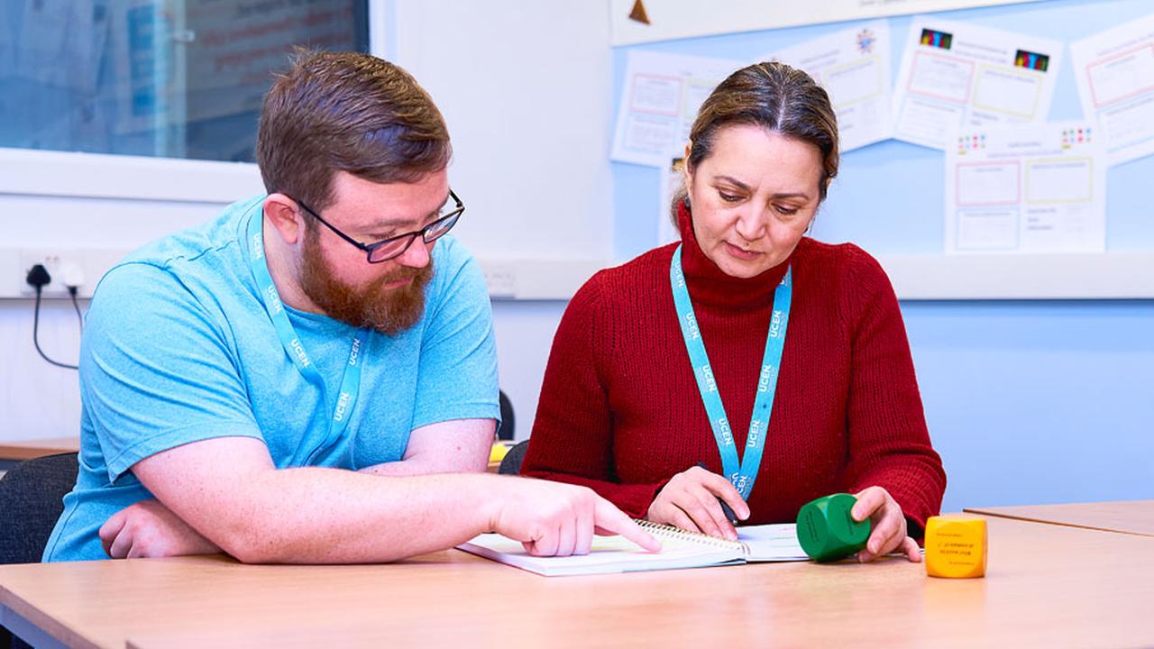 collaborating with a fellow learner during an education course.