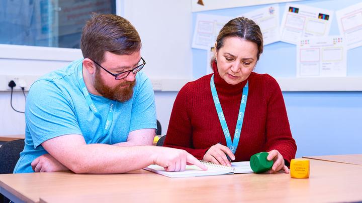 collaborating with a fellow learner during an education course.