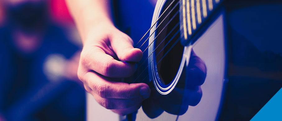 Close-up of someone playing an acoustic guitar