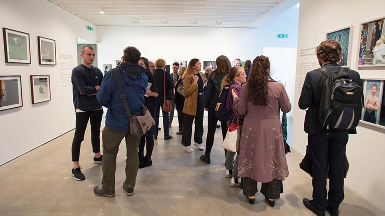 Guests view an exhibit at the Open Eye gallery.