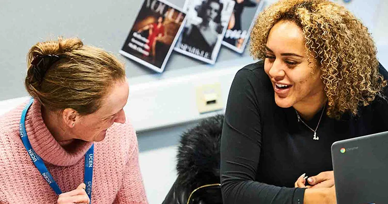 Mature student talking and laughing with a tutor