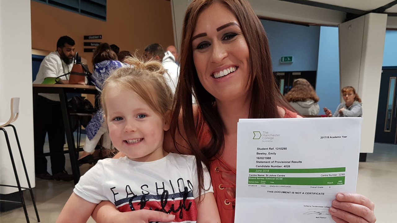 Emily Bewley and her child posing for a photo with her GCSE results