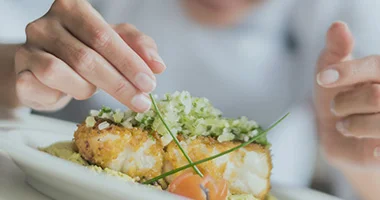 Chef preparing a meal in a kitchen