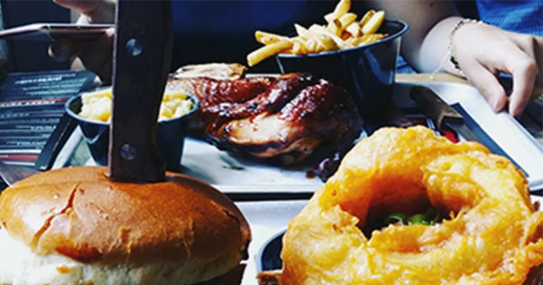 Close-up of a burger and onion rings