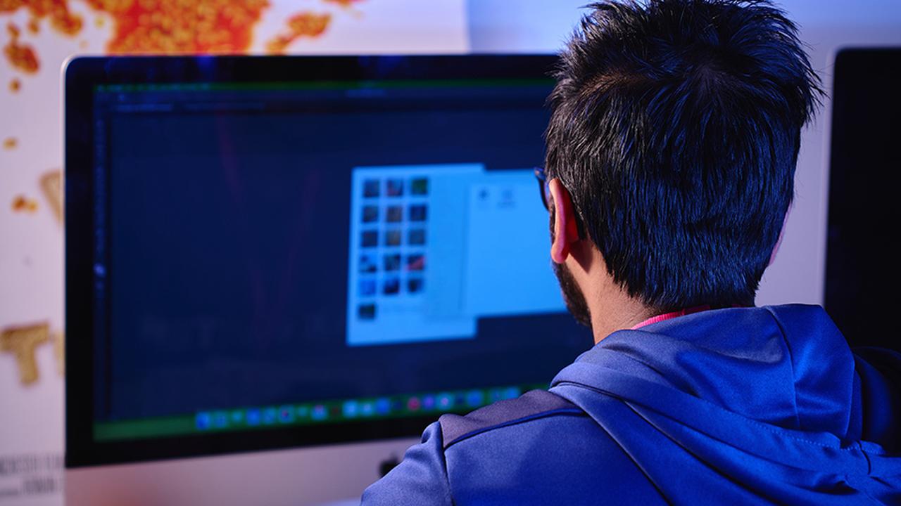 Graphic Design student sat using a computer.